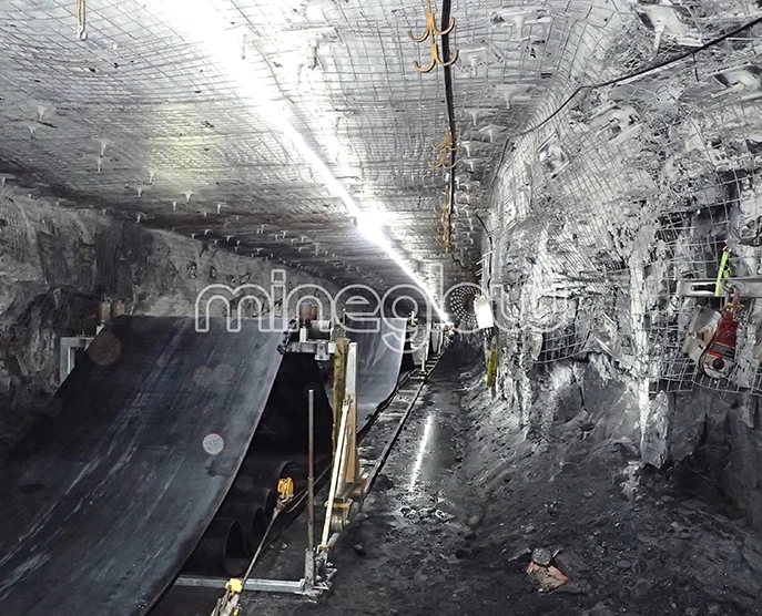 Mineglow LED strip lighting illuminates underground mine conveyor